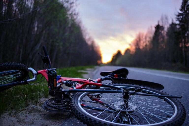 A bicycle accident scene at sunset.