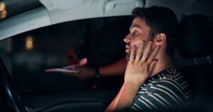 Traffic stop, man and stress in car with police, dui and frustrated for drunk driving or speeding at night.